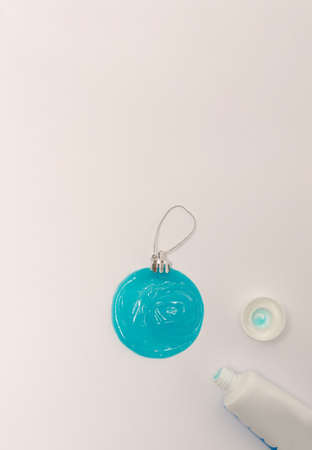 Blue Christmas ornament made of toothpaste on white background. Flat lay creative concept.の写真素材