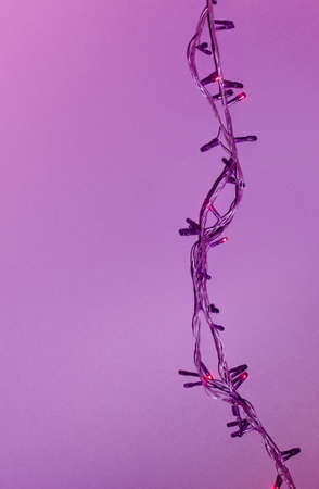 Minimal New Year concept with purple Christmas light bulbs on purple background.の写真素材
