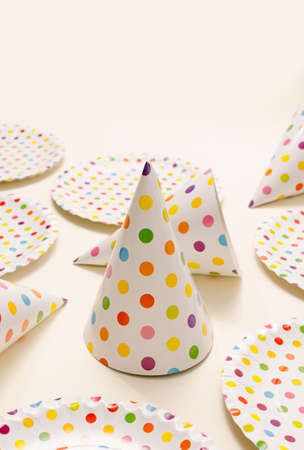 Party set with polka dots. Plates and caps. Flat lay.の写真素材