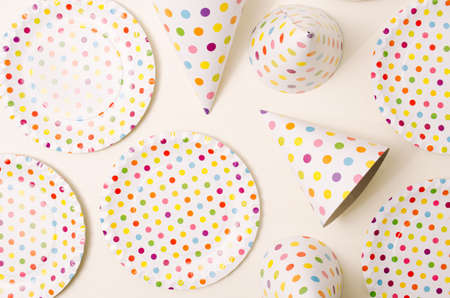 Party set with polka dots. Plates and caps. Flat lay.の写真素材