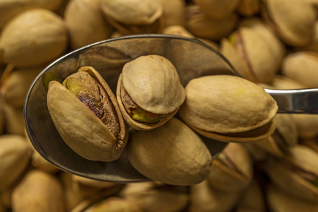 Pistachios close up and spoon of pistachiosの写真素材
