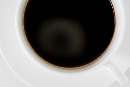 Coffee in a coffee cup, top view, white backgroundの写真素材