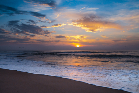 Sunset on the beach, blue ocean and colorful skyの写真素材
