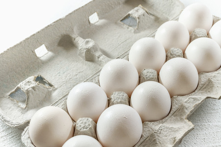 Farm Fresh White Eggs in Carton Box on White, Close up