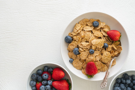 Toasted Oatmeal Flakes with Milk and Fresh Berries, Close up, in White Background, Copy Space.  Good Source of Fiber and Vitaminsの写真素材