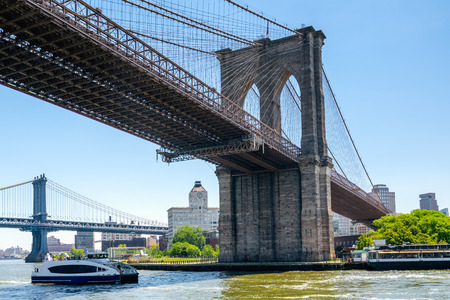 Under The Brooklyn Bridge, New York City. East River, Brooklyn Bridge and Manhattan Bridge. Boat Tour Journeyの写真素材