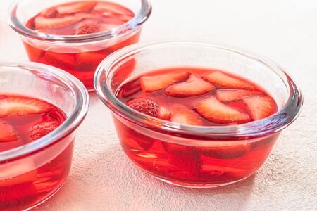 Strawberry Jelly with Slices of Strawberry in a Glass Bowls Top View. Fresh Dessert, Mousse, Jelly, Marmaladeの写真素材