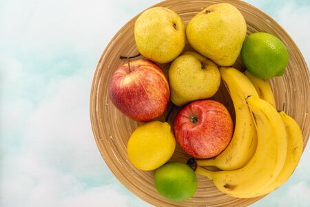 Fruits on a Plate. Apples, Pears, Bananas, Lemon, and Limes. Top View, Copy Spaceの写真素材