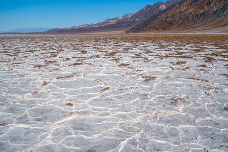 Badwater flats and mountains range in Death Valley National Park, Californiaの写真素材