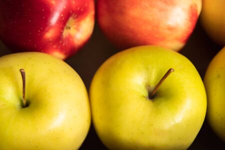 Apples. Autumn harvest. Fresh organic red and yellow apples in container, close up, top viewの写真素材