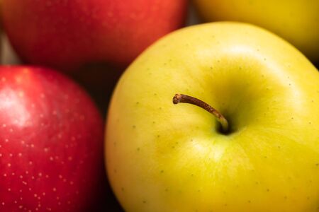 Apples. Extremely close up of yellow and red apples, top viewの写真素材