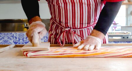 Peppermint candy. Chef making traditional holiday peppermint candies. Close up processの写真素材