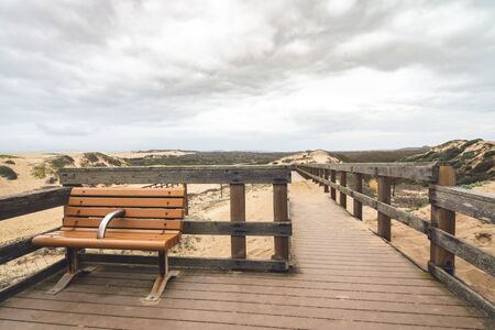 Rustic Wood Beach Boardwalk Through Sand Dunes. Oso Flaco Lake Natural Area State Park, Californiaの写真素材