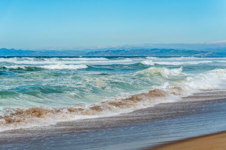 Beautiful seascape. Blue waves breaking on the shore.