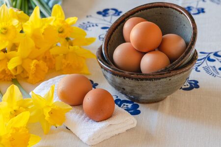 Eggs and beautiful daffodil flowers bouquet close up. Still life, Easter conceptの写真素材