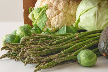 Fresh organic vegetables from farmers market. Asparagus, Brussels sprouts, avocado, cauliflower, and white cabbage close upの写真素材