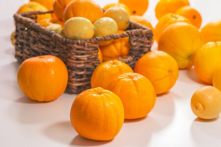 Fresh ripe organic oranges and lemons close up on white backgroundの写真素材