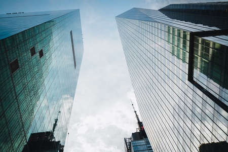 New York City/USA - May 24, 2019   New York city modern architecture. Skyscrapers and cloudy sky background, low angle view.のeditorial素材