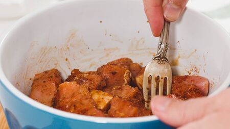 Chopped marinated pork meat. Close up in a bowl, ready for cookingの写真素材