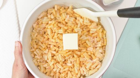 Creamy delicious macaroni and cheese close up in a bowl, view from aboveの写真素材