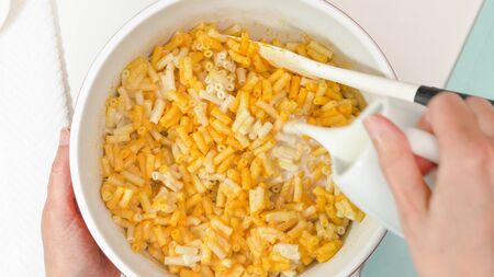 Creamy delicious macaroni and cheese close up in a bowl, view from aboveの写真素材