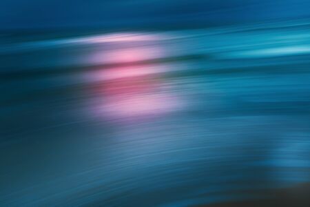 Sunset Over The Sea. Abstract Seascape Background. Water Surface and Sun Reflection. Beautiful blue, turquoise, and pink colorsの写真素材