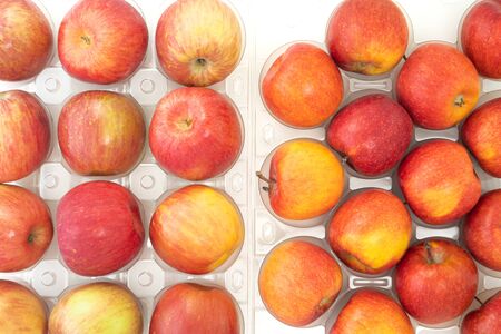 Fresh red apples close up on white background, view from above.の写真素材