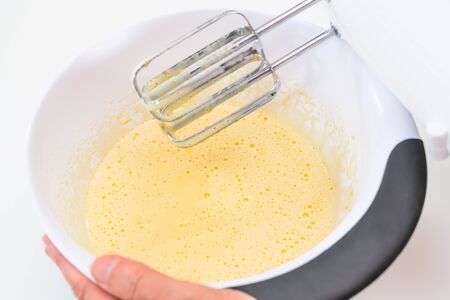 Mixing biscuit dough with an electic mixer. close up process. Cake batter making.