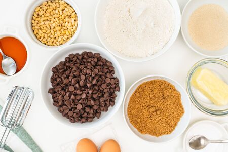 Chocolate chips and ingredients for baking needs close up on a kitchen table. Chocolate Chip Cookies recipeの写真素材