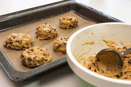 Chocolate chip cookies xlose up on a parchment-lined baking sheetの写真素材