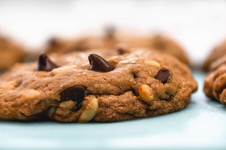 Chocolate chip cookies with pine nuts. Homemade old-fashioned Chocolate Chip Cookies close up. American cuisine, dessertの写真素材