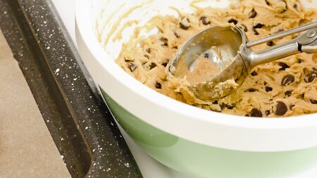 Chocolate Chip Cookie batter close up in a bowl on white kitchen table.の写真素材