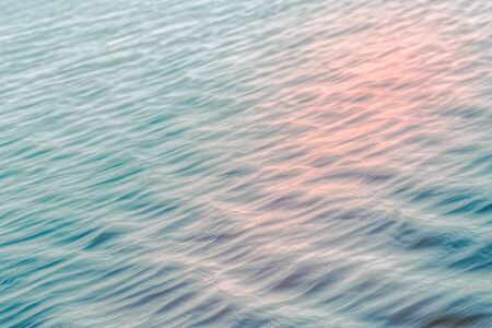 Soft light abstract background, water surface. Calm sea with beautiful sunlight reflections. Play of ripples, motion blur, calm, tranquil scene.の写真素材