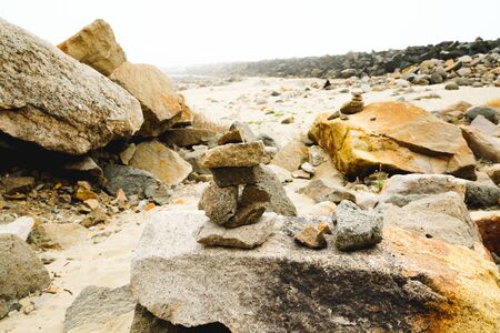 Rocks on the beach on an overcast dayの写真素材