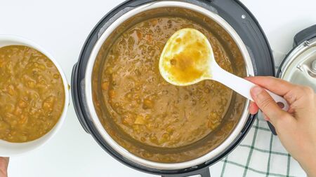 Creamy lentil soup cooked in multi cooker close up directly from aboveの写真素材