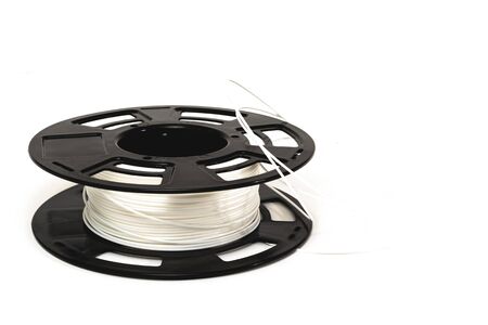 3D Printer Plastic Filament. Spool of white thermoplastic wire for 3d printing close up isolated on white backgroundの写真素材
