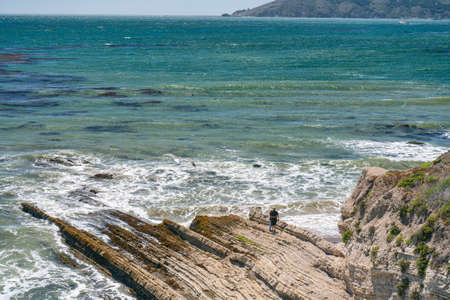 Pismo Beach, California/USA - June 7, 2020  Couple on the beach surrouded by rocky cliffs enjoying ocean view. Pismo beach cliffs, beautiful California Central Coastのeditorial素材