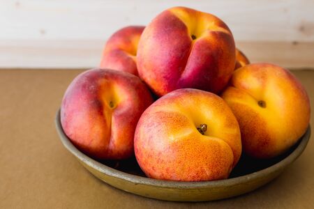 Peaches close up. Fresh ripe organic peaches on a plateの写真素材