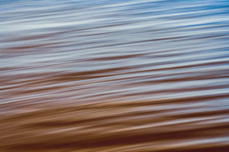 Abstract seascape background. Tropical beach sunset. Long exposure, play of ripples, tranquil sceneの写真素材