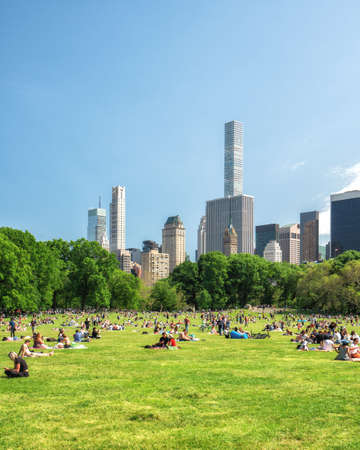 New York City/USA - May 25, 2019  People Resting in  Central Park, Beautiful Sunny Day in New York City. Manhattan Skyline as it viewed from the Park.のeditorial素材