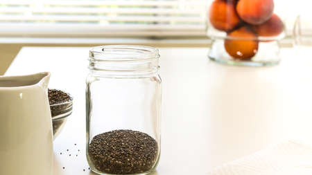 Chia seeds close up in a glass bowl on white background. Chia seeds pudding with fresh fruits recipe.の写真素材
