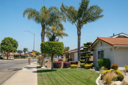 Street view and beautiful houses with nicely landscaped front the yard in small town in California.の写真素材