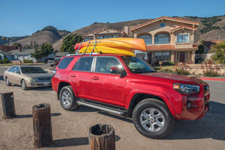 Shell Beach, California/USA- July 23, 2020 Shell Beach street view, cars with kayaks  mounted on...