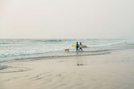 Morro Bay State Park, California/USA  - September 13, 2020.  Surfing girls with their surf boards on the beach, Morro Bay, Californiaのeditorial素材