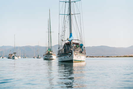 Bay, California/USA - September 23, 2020  Yachts anchored in Morro Bay harbor, beautiful mountains on backgroundのeditorial素材