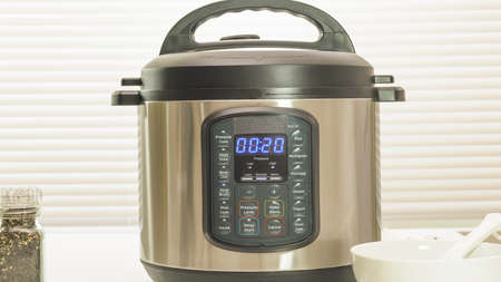 Modern electric multi cooker close up on kitchen table. Up to 20 minutes cooking time selectionの写真素材