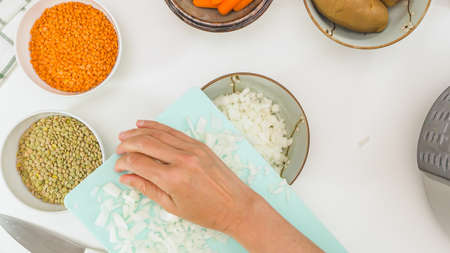 Chopped white onion close up on chopping boardの写真素材