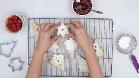 Christmas shortbread cookies with raspberry jam recipe, close up baking process. Baked cookies close...