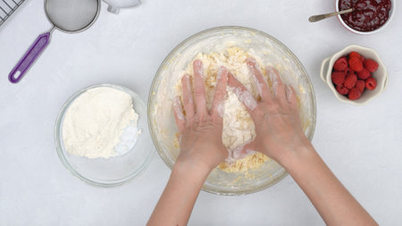 Christmas shortbread cookies with raspberry preserves recipe. Chef mixing ingredients in a glass...