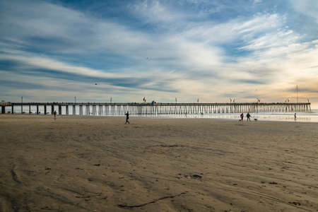 Pismo Beach, California, USA - January 1, 2021 Sunset on Pismo Beach. Wide sandy beach, a long...